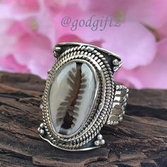 This stunning Cowrie Shell Gemstone Ring is made of polished, textured, and oxidized sterling silver with a handcrafted sterling silver ring setting. The ring has a beautiful and unique design with a high polish that gives the ring a luxe look. This friendship Gift is perfect for everyday wear and is sure to be a conversation starter. Metal : 925 Sterling Silver Weight (Gms) : 9 Gms Approx Style : Cocktail Ring Size :  All Sizes Healing Properties : ------------------------------------------------------------------------------------ The cowrie shell has many uses and meanings. ... Spiritually, according to African legend, if you are attracted to cowrie shells you could be family to an Ocean Spirit of wealth and earth. It also represents Goddess protection which is very powerful and connect Bohemian Carved Sterling Silver Jewelry, Bohemian 925 Stamped Toe Rings, Handmade Silver Bohemian Rings, Handmade Bohemian Silver Rings, Bohemian Handmade Silver Rings, Bohemian Engraved Open Ring, Bohemian Sterling Silver Ring With Oxidized Finish, Bohemian Style Engraved Toe Ring Jewelry, Bohemian Rings With Oxidized Finish For Anniversary