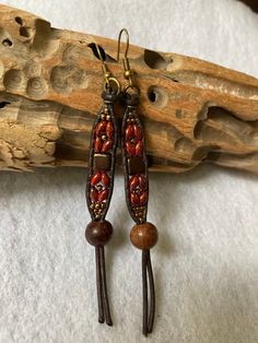 "These long hanging Boho Style earrings are made with Bronze Luster Opaque Red SuperDuo Beads, along with Czech Glass Deep Bronze Tile bead. They have been accented with Seed Beads. I have also added a large wooden bead, all which has been beaded onto brown leather. There is an antique brass tone french earwire for ease of wearing. These earrings measure just about 3-5/8\" inches long, which includes the attached earwire. See picture. They are about 3/8\" inches wide at the beaded portion, and the wooden bead, is just about 1/2\" inch wide. These are very lightweight, and move freely. Free shipping in the US.  Thanks so much for looking!" Adjustable Brown Earrings With Colorful Beads, Adjustable Wooden Beaded Earrings As Gift, Adjustable Festival Earrings With Wooden Beads, Adjustable Brown Beaded Earrings With Dangling Beads, Adjustable Brown Beaded Earrings With Large Beads, Festival Earrings With Wooden Beads, Adjustable Brown Beaded Earrings For Festival, Gift Wooden Beaded Earrings, Brown Large Beaded Dangle Earrings