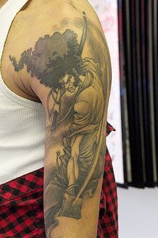 a man with a tattoo on his arm