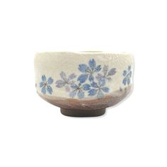 a white and blue bowl with flowers on it