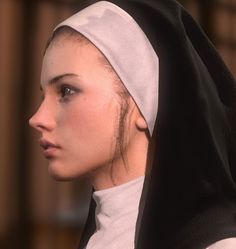 a woman in a nun outfit looking off into the distance