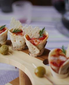 small appetizers with olives and bread on a wooden platter at a restaurant