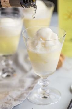 two glasses filled with ice cream on top of a table