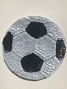 a soccer ball made out of sequins on a white surface with black dots