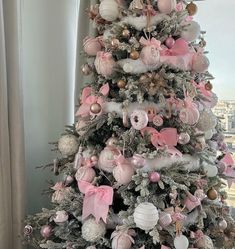 a decorated christmas tree with pink and white ornaments