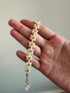 An elegant, hand-made, daisy beaded bracelet in a pearl luster finish with a gold flower center. Gold hardware utilized, finished with a cute flower charm at the end! Hand-made to order! Made in a smoke-free and pet-free environment! Lengths vary in sizes. There are 8 different length options available. Lengths range from 13cm to 20cm in length, and can vary even further depending on which jump-ring you clamp the lobster claw to. Flower Beaded Bracelet, Ring Man, Flower Center, Cute Flower, Gold Flower, Flower Charm, Gold Flowers, Daisy Flower, Jump Rings