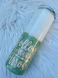 a green and white tumbler sitting on top of a fur covered floor with the words hello you're awesome written on it