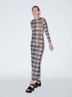 Designed to hug the body with a fitted and sensual shape, Rosetta Getty’s seasonal Plaid Mesh fabrication lends style to this crewneck maxi dress. Cut with a slim, straight silhouette, a high slit up the back allows for ample movement and ease. Exclusive to Rosetta Getty, the Plaid Mesh Jersey is crafted in Italy with a stretchy feel. The enduring two-tone plaid pattern allows for classic versatility and a timeless sensibility. Crewneck Long sleeves Concealed back zip 92% Polyamide / 8% Elastane FINAL SALE, NO RETURNS OR EXCHANGES Long Sleeve Mesh Dress, Maxi Dress Designs, Mesh Jersey, Rosetta Getty, Mesh Maxi Dress, Denim T Shirt, Pleated Maxi Dress, Strapless Maxi Dress, Crewneck Dress