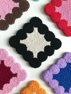 crocheted coasters in different colors and shapes