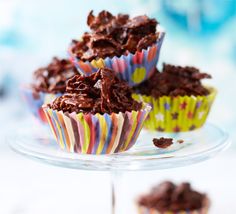 three cupcakes with chocolate frosting sitting on a plate