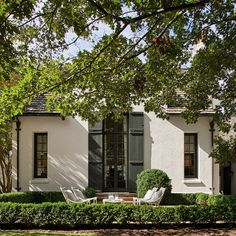 a white house with black shutters and windows