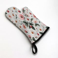 an oven mitt with flowers on it