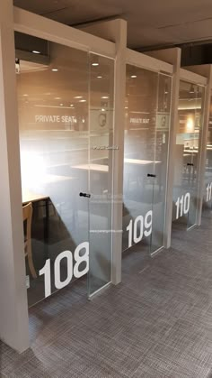 an empty room with glass doors that say private seat and 1080 on the wall