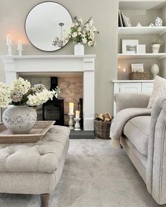 a living room filled with furniture and a fire place in front of a white fireplace