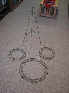 an image of a piece of art on the floor with wires in front of it