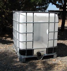 a large white container sitting in the middle of a field