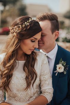 a bride and groom are looking at their wedding rings