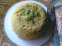 a white plate topped with rice and a fork