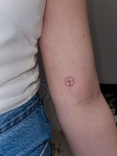 a small four leaf clover tattoo on the arm