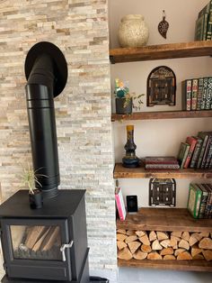 there is a wood burning stove in the living room next to some bookshelves