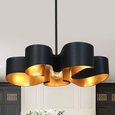 a black and gold chandelier hangs from the ceiling