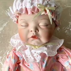 a baby doll that is wearing a pink dress