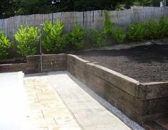 an outdoor garden area with gravel and plants