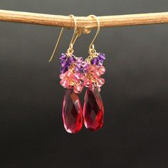 "Multi Gemstone Earrings, Red Quartz, Pink Topaz and Amethyst Earrings A stunning red-coloured Quartz Briolettes are suspended from a cluster of Pink Topaz and Amethyst beads. The Briolette and The gems are wrapped with high quality 14k gold filled wire and swing from a gold filled hook. These are natural, not colourd excellent AAA quality gems, beautifuly faceted and sparkling. An elegant and feminine, chic statement earrings, perfect for special occasion, wedding, holidays or as a Gift for Her Red Briolette Earrings With Ear Wire, Handmade Red Briolette Earrings, Red Briolette Earrings For Anniversary, Red Dangle Jewelry With Gemstone Accents, Red Gemstone Cluster Earrings For Gift, Red Gemstone Accented Drop Earrings, Red Gems, Flower Earrings Gold, Unique Handcrafted Jewelry