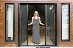 a woman standing in the doorway of a house