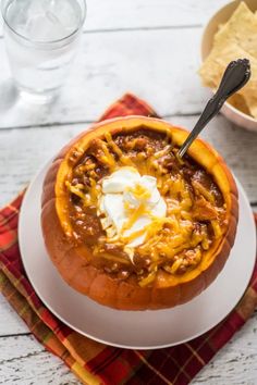 a white plate topped with chili and cheese