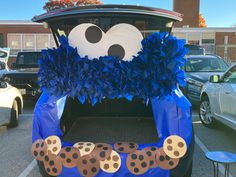 the trunk of a car decorated with blue and black decorations, including a cookie monster