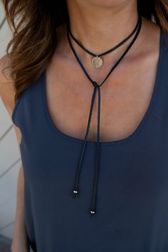 The Leather Wrap Choker/Lariat Tie is a fun and versatile necklace! Wear as choker or lariat tie. Choose either a sterling silver or 14K gold filled 5/8 hammered or blank disc to compliment the black or brown genuine leather wrap. *CHOOSE between a hammered or blank disc ...........and....... BLACK or BROWN leather  - premium 16mm (5/8)14k Gold Filled or Sterling Silver - signature hammered finish on the disc - 47 genuine leather wrap with gold or silver bead at each end - each... Elegant Lariat Jewelry With Adjustable Cord, Gold Lariat Necklace With Adjustable Chain For Festival, Adjustable Lariat Choker As Gift, Lariat Choker With Adjustable Length Gift, Adjustable Gold Lariat Choker, Festival Lariat Jewelry With Adjustable Cord, Adjustable Lariat Choker Necklace For Party, Elegant Lariat Necklace With Adjustable Length For Festivals, Adjustable Cord Party Jewelry