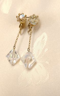 "These Mid-century style, Clip-on vintage dangle earrings are in very good condition.  The clips function well and the gold finish is intact. The AB crystal beads are iridescent, very sparkly and brilliant. The style is feminine and will look great on you. The length and size of the beads are just right to be noticeable but not too overpowering. Earring length 1.25\".  Crystal beads 5 and 8mm.  Vintage 1960s costume jewelry earrings.   Newly cleaned with professional grade jewelry cleaner. Earri 1960s Costume, 60s Earrings, Holiday Dates, Costume Jewelry Earrings, Etsy Earrings Dangle, Earrings Vintage, Jewelry Cleaner, Vintage 1960s, Vintage Earrings