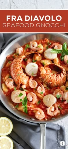 a white bowl filled with shrimp and sauce on top of a table next to lemon wedges