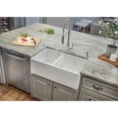 Enduring in beauty and performance, this apron front kitchen sink is a fashionable kitchen fixture with modern farmhouse charm. The white sink is sculpted from fireclay and exposed to extreme temperatures, developing a smooth enamel finish that's strong, stain resistant and stands up to everyday use. The versatile undermount format can be installed as floating sink or flush beside kitchen cabinetry. Crafted by hand with exceptional care, subtle design details throughout the double bowl basin and front panel enhance the sink's artisanal appearance. Two coordinating drain assemblies with strainer baskets and two stainless steel grids complete the package. California residents see Prop 65 WARNINGS Fade-resistant white glazed finish stays shiny and bright for years to come Suitable for install Apron Front Kitchen Sink, Apron Sink Kitchen, Kitchen Fixture, Farmhouse Apron, Kitchen Diy Makeover, American Kitchen, Double Bowl Kitchen Sink, Bowl Kitchen Sink, Smitten Kitchen