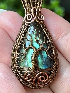 This labradorite wirewrap features a Tree of Life, timeless symbol of change, harbinger of rebirth, and herald of new life. *Notes on labradorite*  "For self-discovery, it is excellent for awakening one's own awareness of inner spirit, intuition and psychic abilities. Labradorite is also the most powerful protector of the mineral kingdom, creating a shielding force throughout the aura and strengthening natural energies from within." "Labradorite is an important crystal because it can help you with your physical, emotional, and spiritual healing. It's a great companion crystal that can guide you in your journey of self-discovery. It can work on enhancing your intuition and activating your psychic abilities." *made using non tarnish copper wire* Nature-inspired Hand Wrapped Labradorite Necklace, Bronze Wire Wrapped Labradorite Necklaces, Bronze Labradorite Wire Wrapped Necklaces, Life Notes, Tree Of Life Wire, Timeless Symbol, Psychic Abilities, Spiritual Healing, Wrapped Pendant