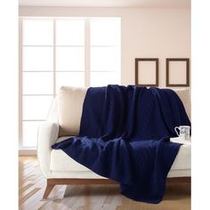 a couch with a blue blanket on top of it