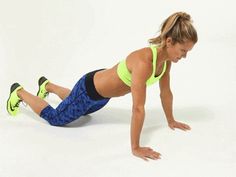 a woman is doing push ups on her stomach