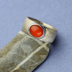 "Fire Opal Ring, Natural Cats Eye Fire Opal Cabochon Silver Bezel Ring, Red Orange Opal, Unisex Sterling Silver Ring I hand made this gorgeous Fire Opal ring just for you! Bright orange Red Fire Opal from Mexico. Sorry could not capture the rolling cat's eye that moves as you tilt the gem, but it is there. Very rare to see a cat's eye in a fire opal. You can see the moving cats eye, the chatoyancy when you tilt and move the gemstone. I bezel set this 9.5 x 8 MM oval Cat's Eye Fire Opal cabochon Red Bezel-set Round Band Rings, Red Cabochon Ring Jewelry, Carnelian Cabochon Ruby Ring, Red Carnelian Cabochon Ruby Ring, Red Ruby Cabochon Rings, Red Carnelian Jewelry With Cabochon, Red Bezel Setting Ring, Red Oval Cabochon Ruby Ring For Gift, Red Bezel Set Ring