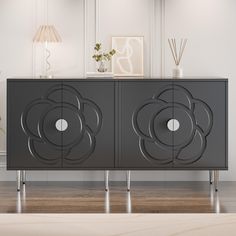 an art deco sideboard with two doors on each side and a flower design painted on the front