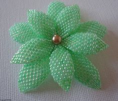 a green flower with a pearl in the center