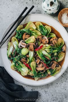 a white plate topped with stir fry vegetables