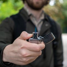 a man holding a lighter in his hand