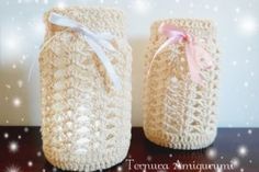 two crocheted jars sitting on top of a table