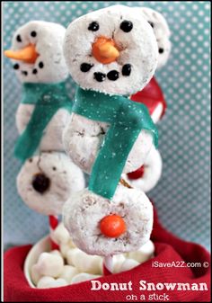 three snowmen made out of marshmallows and one with a green scarf