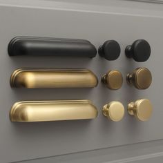 an assortment of knobs and handles on a gray surface, including one for the door