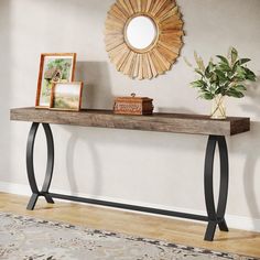 a wooden table topped with a mirror next to a plant