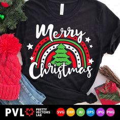 a black shirt with merry christmas tree and rainbows on it, surrounded by other holiday items