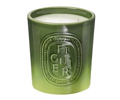 a green candle that is sitting in front of a white background with the words fuer on it