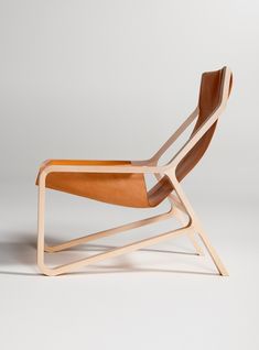 a wooden chair sitting on top of a white floor